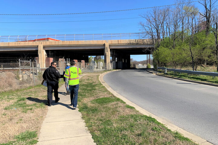 men walking under a bridge