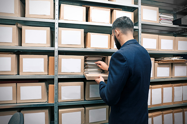 Man with documents in archive
