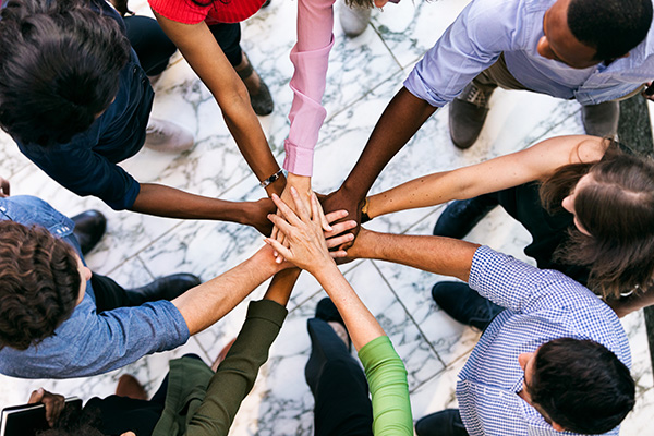 Diverse people all hands in