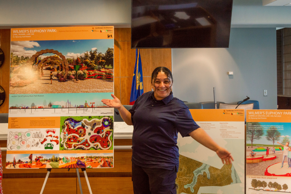 woman poses with playground designs