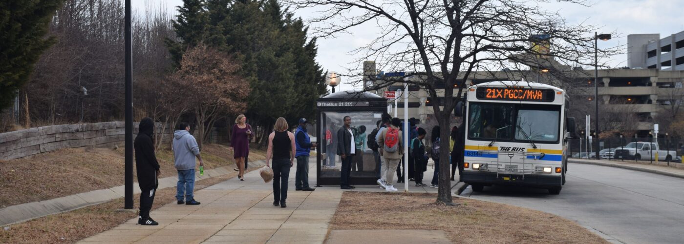 large group of People getting on a bus