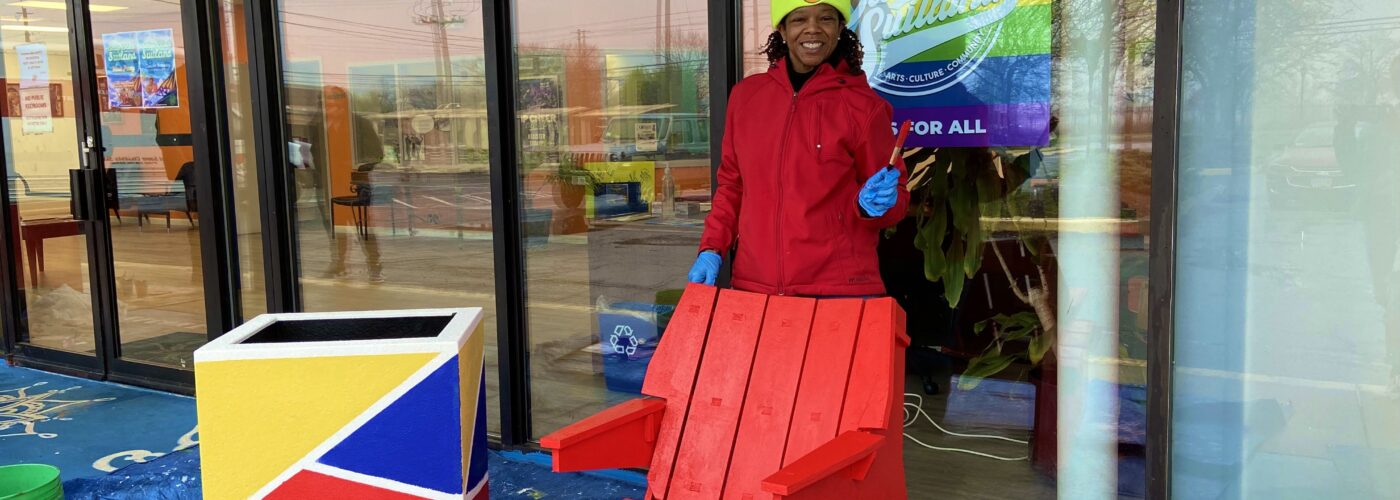 woman painting a wooden chair red