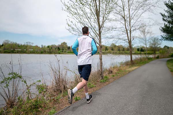 jogger along riverside trail