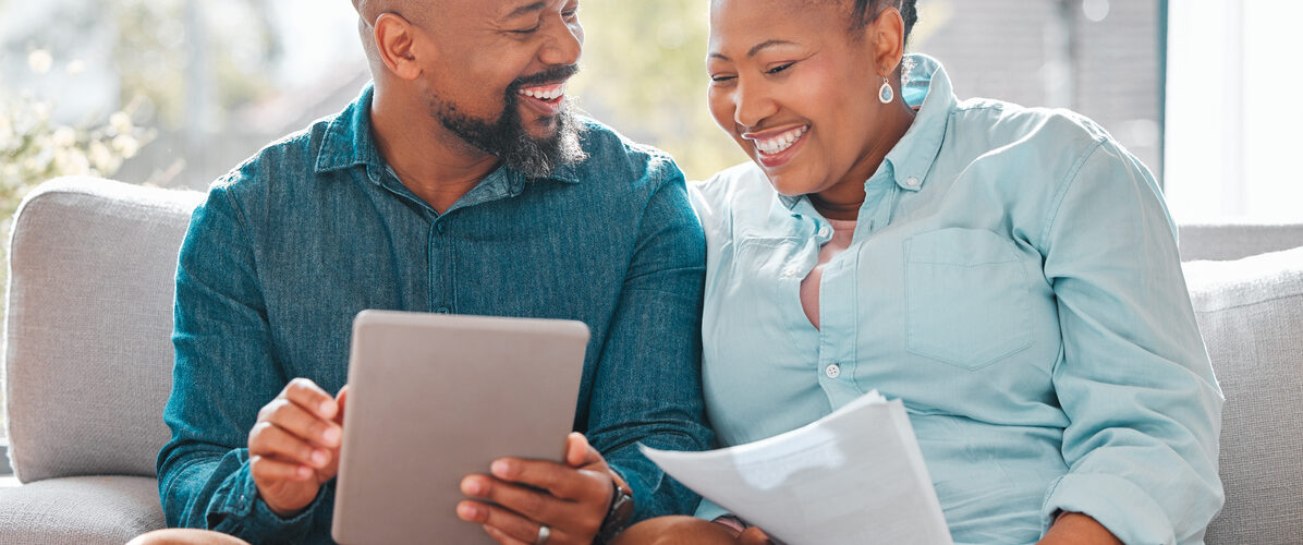 Middle aged happy black Couple consulting their ipad
