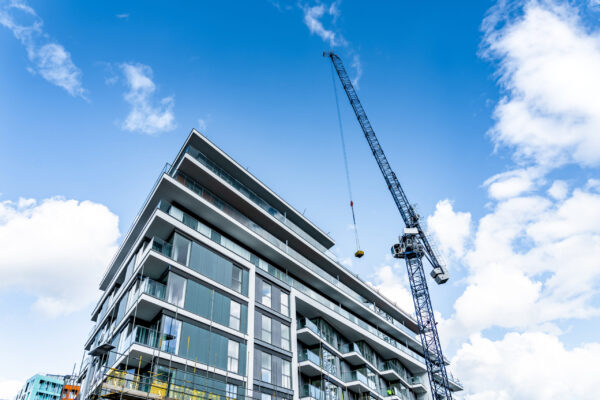 Crane working next to a building.