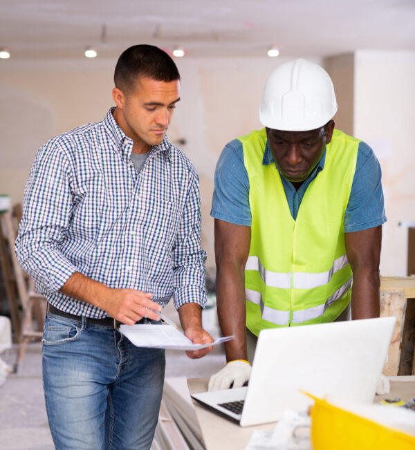 Two men looking over building plans