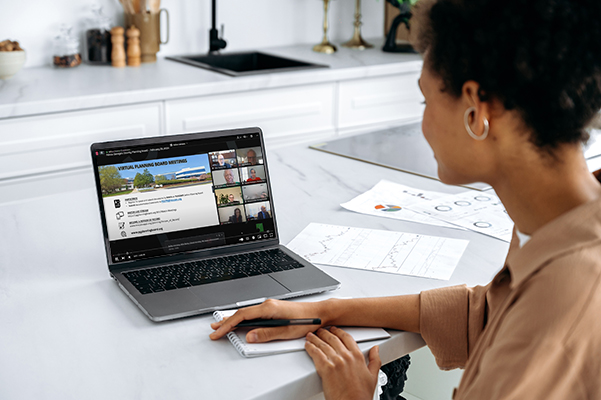 Woman watching a meeting on computer