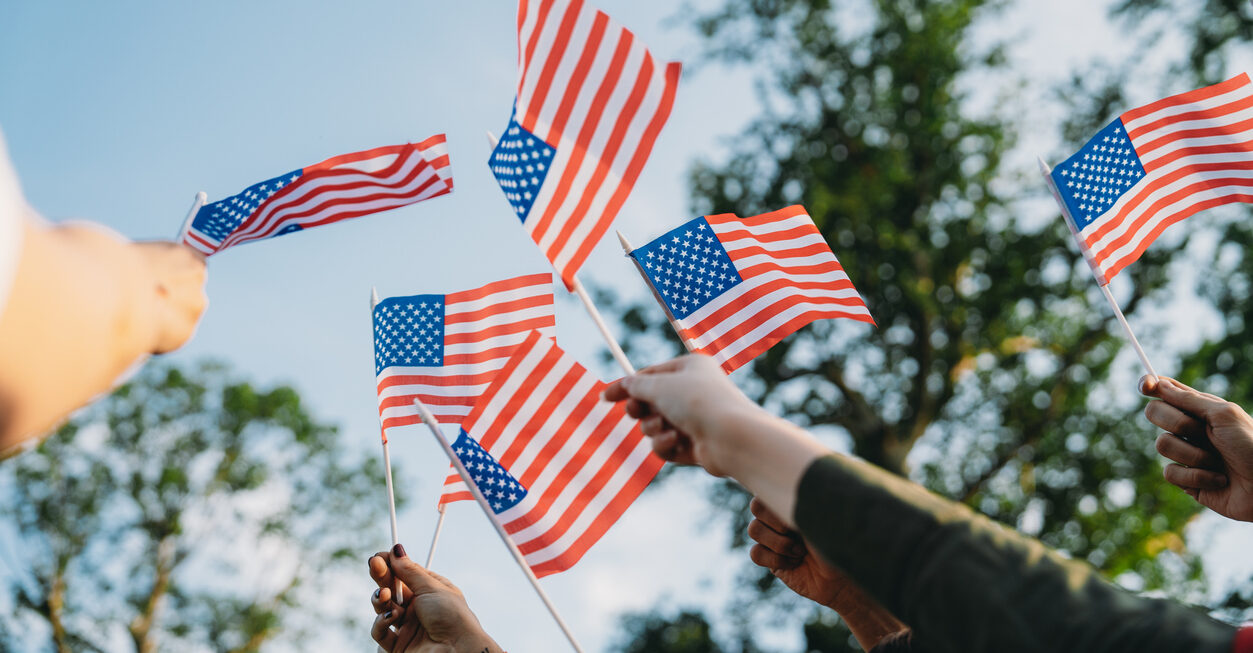 Many hands waving small American flags. Photo by FilippoBacci, istockphoto.com.