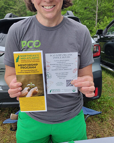 Representative of a mentorship program holds brochure and invitation.