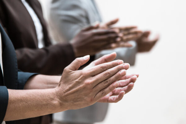 A photo of hands of business colleagues applauding