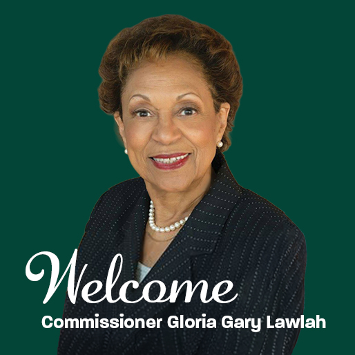 Welcome Commissioner Gloria Gary Lawlah, with a portrait of her wearing a black suit with a small dot pattern and pearls around her neck, on a dark green background.