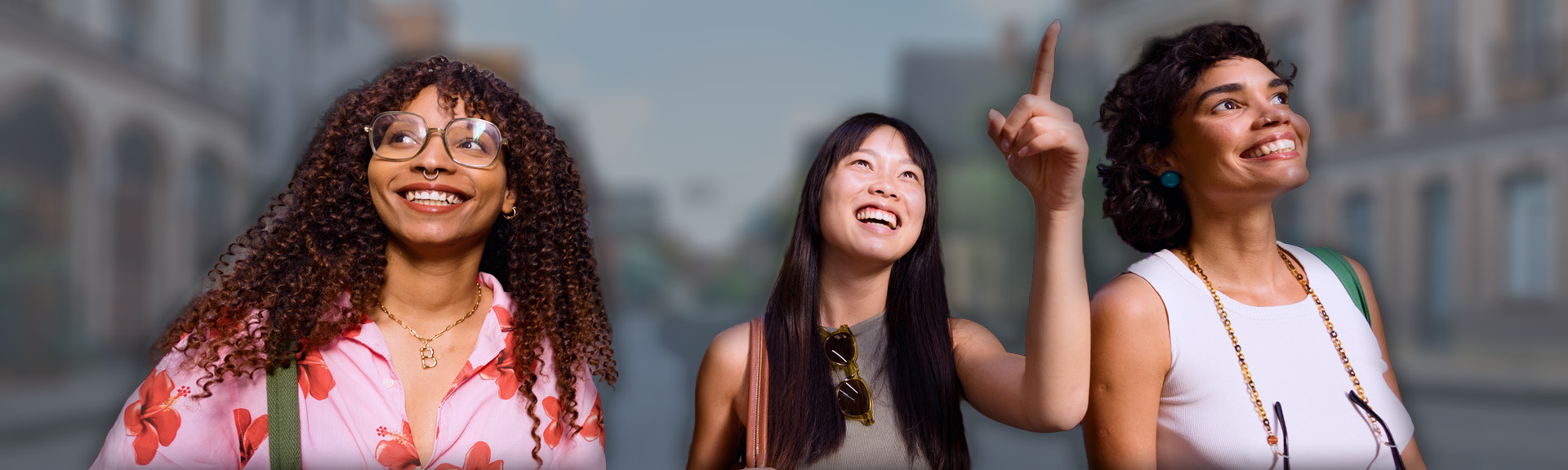 Three woman walking and pointing to nearby attractions.